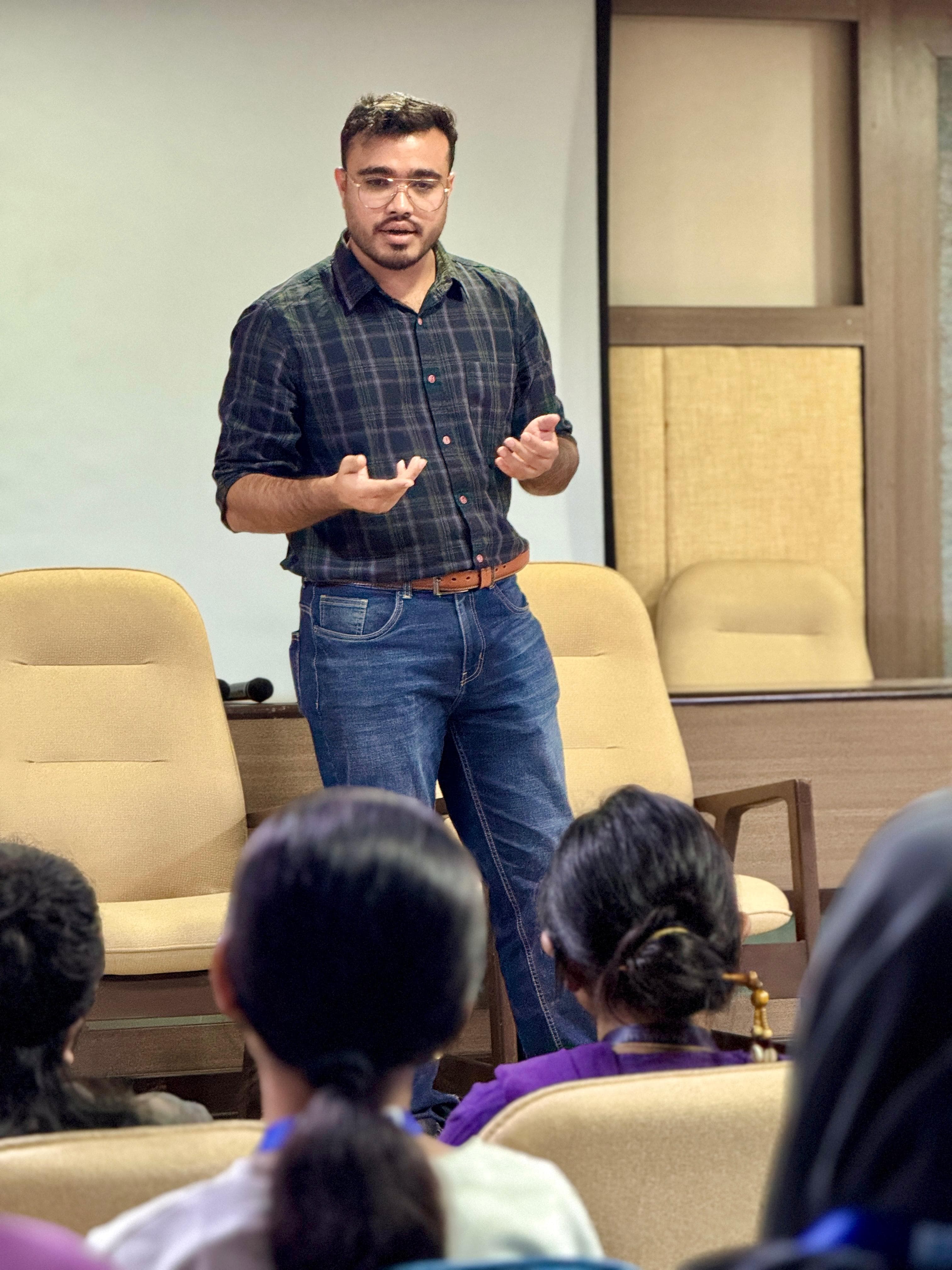 Kshitij talking to a room of students